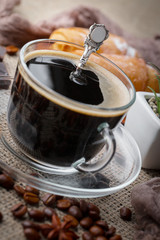 Coffee in a cup and saucer on an old background.