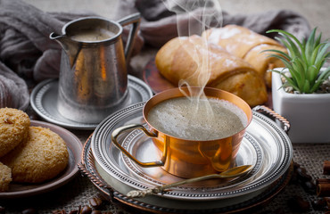 Coffee in a cup and saucer on an old background.