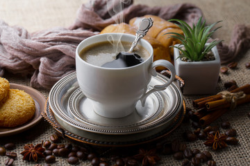 Coffee in a cup and saucer on an old background.