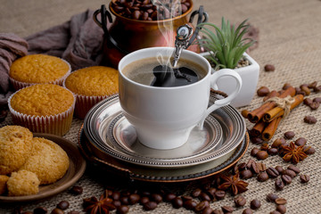 Coffee in a cup and saucer on an old background.