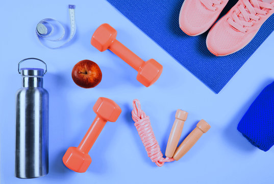 Flat lay shot of sneakers on trendy blue background. © Olga