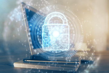 Double exposure of desktop with computer and lock icon hologram. Concept of data safety.