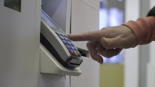 Female hand presses buttons of terminal of payment of purchases closeup. woman customer uses payment terminal to pay for purchases.