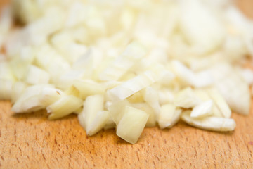 Chopped onions on wooden cutting board