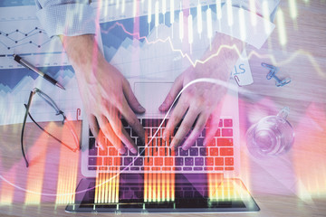 Double exposure of market chart with man working on computer on background. Concept of financial analysis.