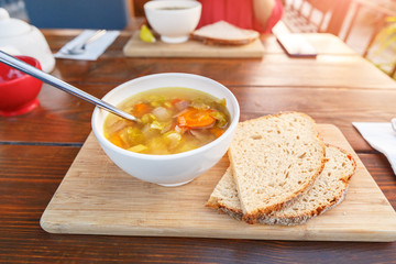 Eating vegetarian soup in outdoor cafe