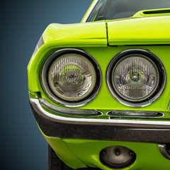 Headlights of a bright green American sports car