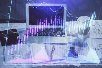 Forex market chart hologram and personal computer background. Multi exposure. Concept of investment.