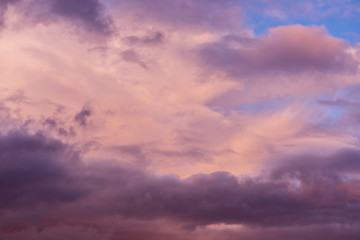 Naklejka na ściany i meble Dramatic sunrise, sunset pink violet sky with clouds background texture