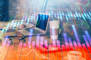 Financial graph colorful drawing and table with computer on background. Double exposure. Concept of international markets.