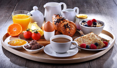 Breakfast served with coffee, juice, croissants and fruits