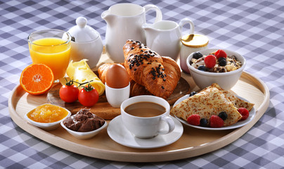 Breakfast served with coffee, juice, croissants and fruits