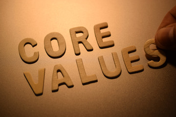 Hand arrange wood letters as CORE VALUES word, close-up