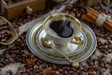 Coffee in a cup and saucer on an old background.