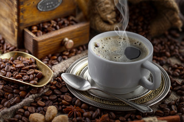 Coffee in a cup and saucer on an old background.