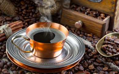 Coffee in a cup and saucer on an old background.