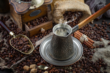 Coffee in a cup and saucer on an old background.