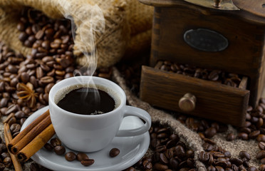 Coffee in a cup and saucer on an old background.