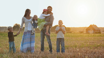 Large family on a background of evening sunset.