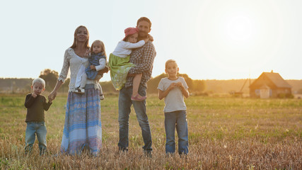 Large family on a background of evening sunset.