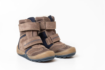 Brown leather stylish children's shoes, boots isolated on white background, close-up.