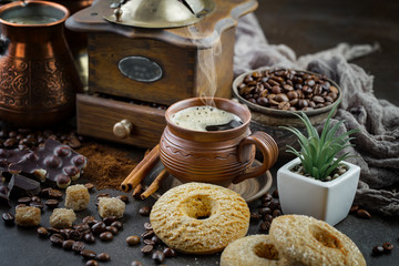 Coffee in a cup on a background of coffee beans, on an old background.