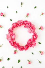 Pink rose flower buds pattern on white background with round wreath frame. Blank copy space mockup. Flat lay, top view minimal floral Valentine's day composition.