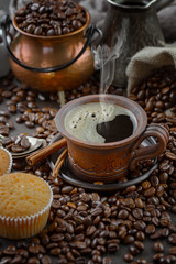 Coffee beans are roasted in a pan with smoke.