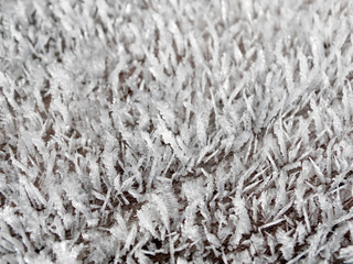winter background with snowflakes crystals patterns and snow on frozen grass