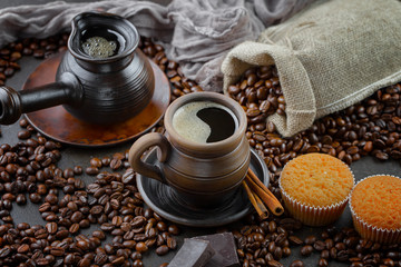 Black coffee beans roast in a pan in the smoke