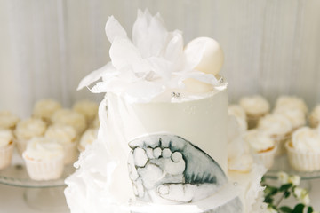 Candy bar. Beautiful white cake with a picture of the child's foot, the Concept of children's birthday parties
