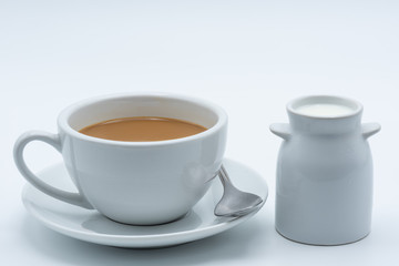 Milk coffee in a ceramic cup on a white background