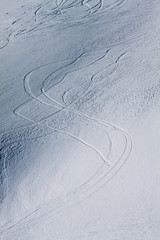 Fototapeta na wymiar Traces of skis on the snow-white tall mighty mountains Elbrus, ski resort, the Republic of Kabardino-Balkaria, Russia