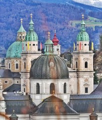 Fototapeta premium Towers and Church of Salzburg with mountains in the back