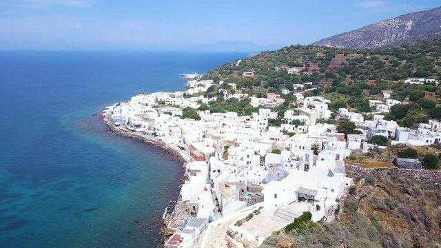 Aerial shot of church and white town on Kos island in Greece. Shot of a drone on a church on a hill. Rotating shot around church on hill.