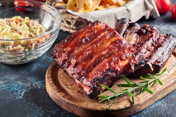Spicy barbecued pork ribs served with BBQ sauce