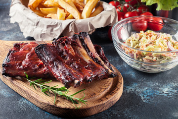 Spicy barbecued pork ribs served with BBQ sauce