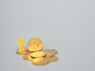 Miniature people as workers is working on the Bitcoin Crypto currency.