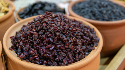 dried grapes in earthenware pots sold in market