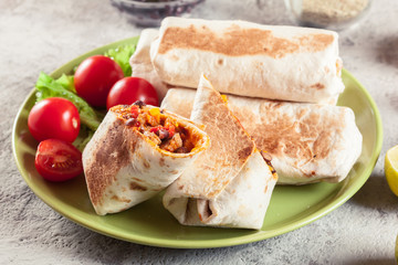 Burritos wraps with mincemeat, beans and vegetables