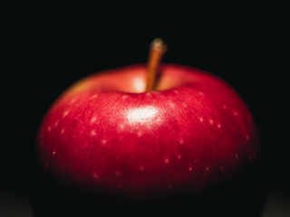 red apple on black background