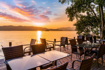 Hangzhou West Lake sunset and outdoor leisure tables and chairs..