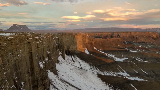 Timelapse of desert landscape lighting up during sunrise in Utah from the Skyline overlook viewing Factory Butte in the Caineville desert.