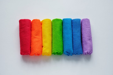 top view flat lay rainbow towels, row of multicolored cotton towels isolated on white