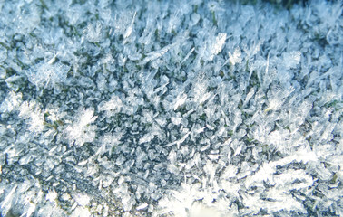 winter background with snowflakes crystals patterns and snow on frozen grass