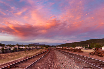 Fototapeta na wymiar View of the gorgeous sunset over the railroad going into the hills, USA