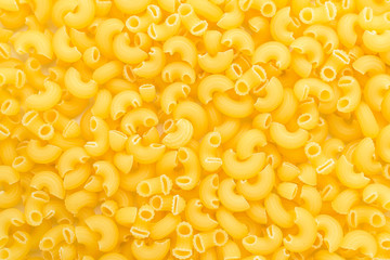 Many dried corneti rigati Italian pasta ready to be cooked, top view or flat lay background of healthy food