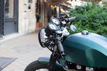 Green motorbike is on the street with beautiful bokeh