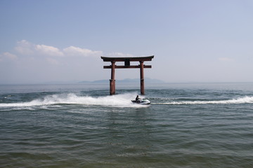 A water scooter and red torii gate, Japan