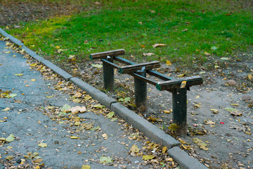 Old broken wooden bench with iron frame. Without the seats. City. Green park. Aged. Abandoned. Poorness. Public space